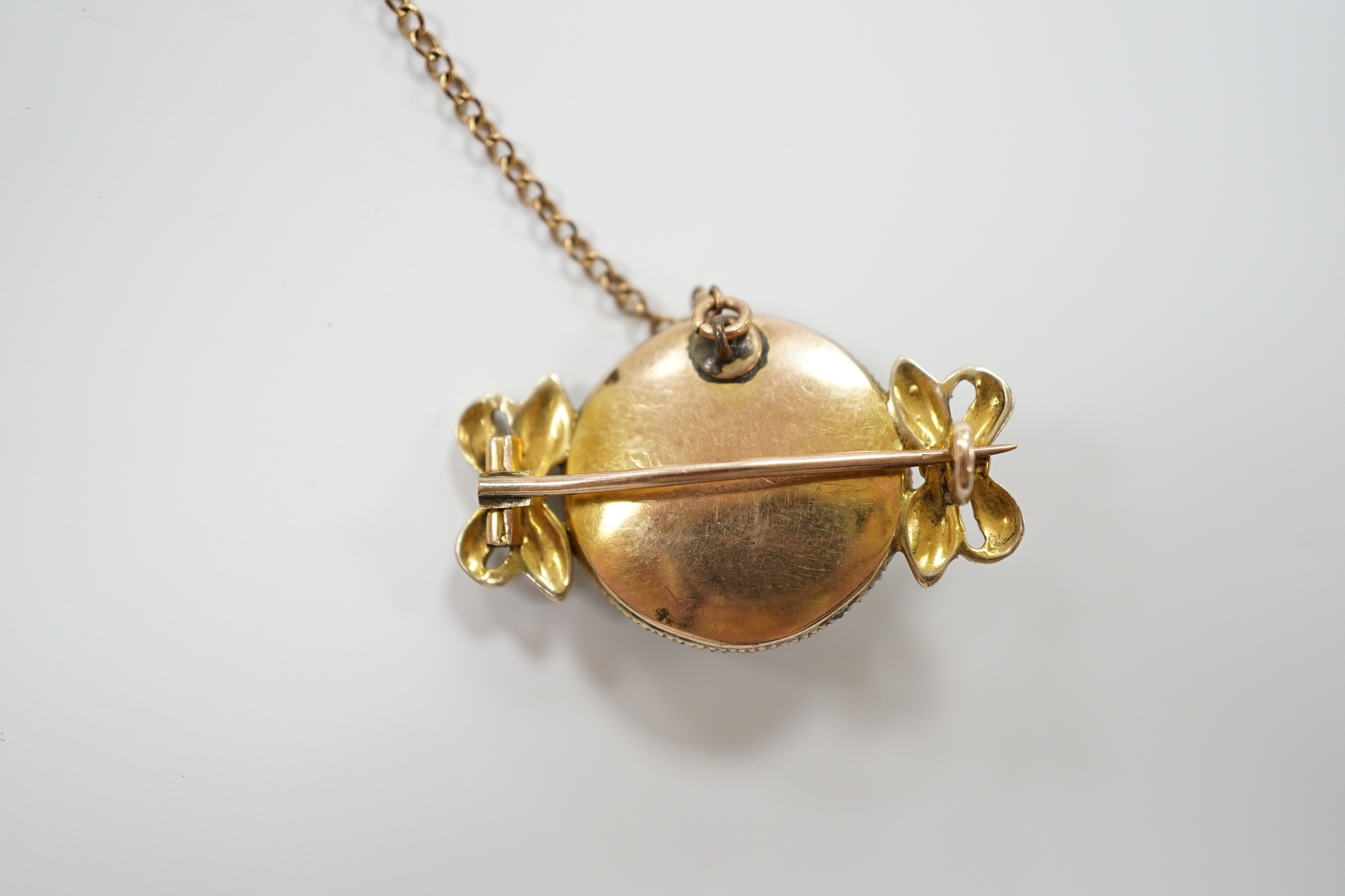 An early 20th century yellow metal, enamel, diamond and seed pearl set brooch, 30mm, gross weight 6.9 grams.